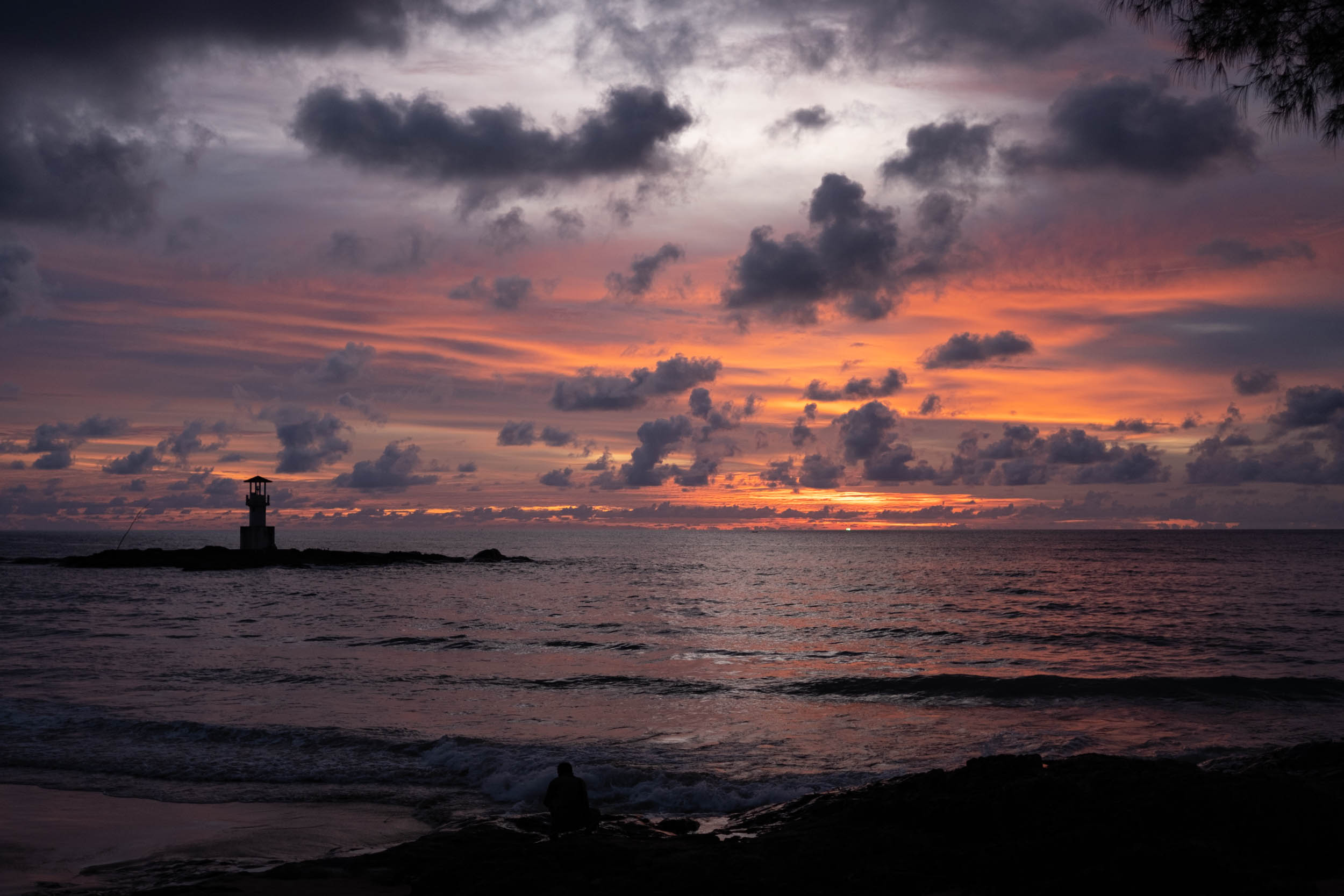 A beautiful sunset at Nang Thong beach, Khao Lak, with a lighthouse on the left hand side.