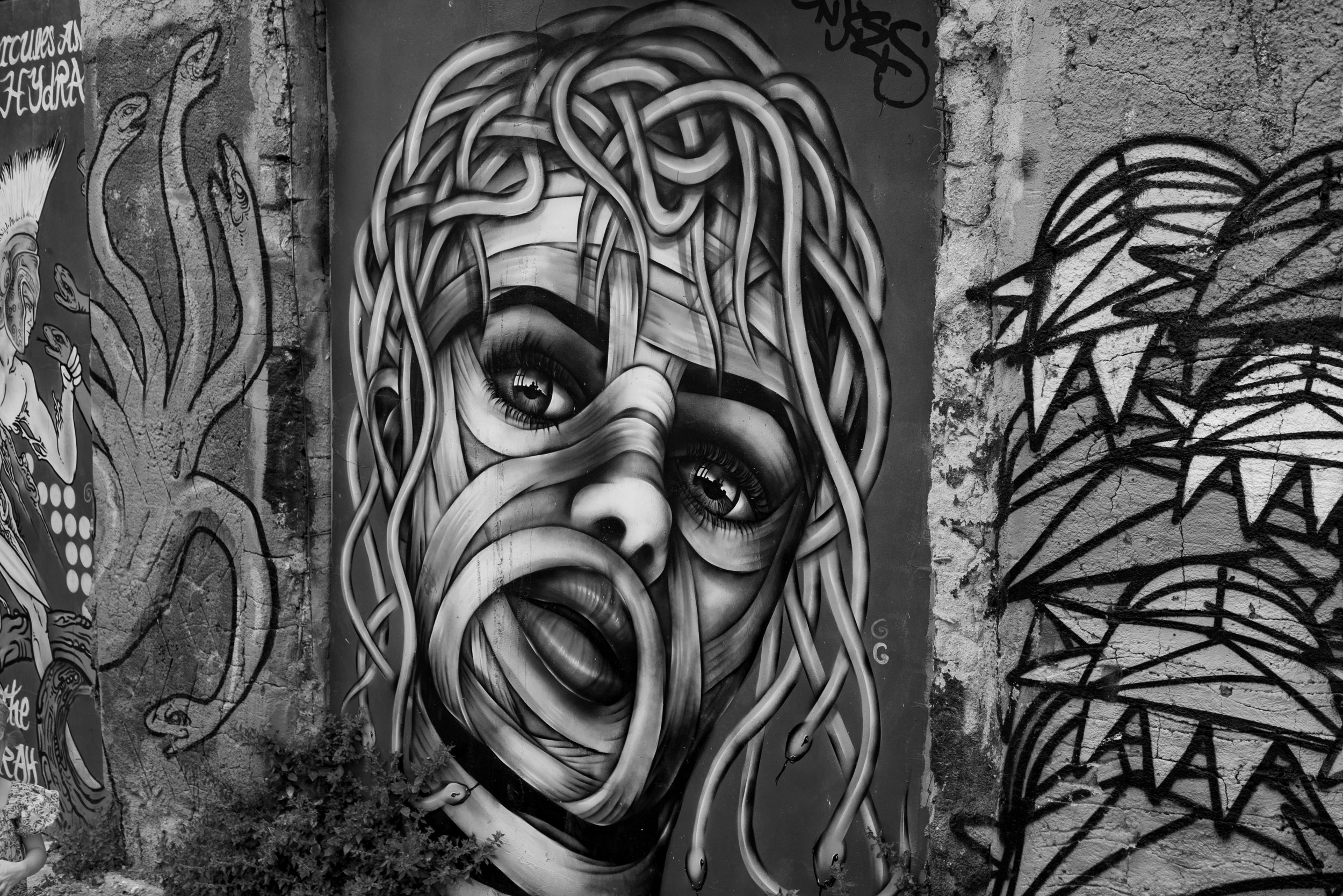 A spray painted medusa graffito in the streets of Athens.