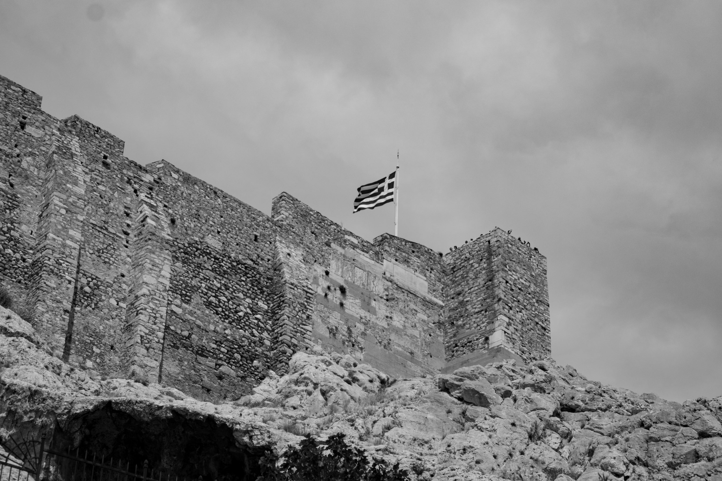 Flag of Greece flapping in the wind on top of the Acropolis in Athens.