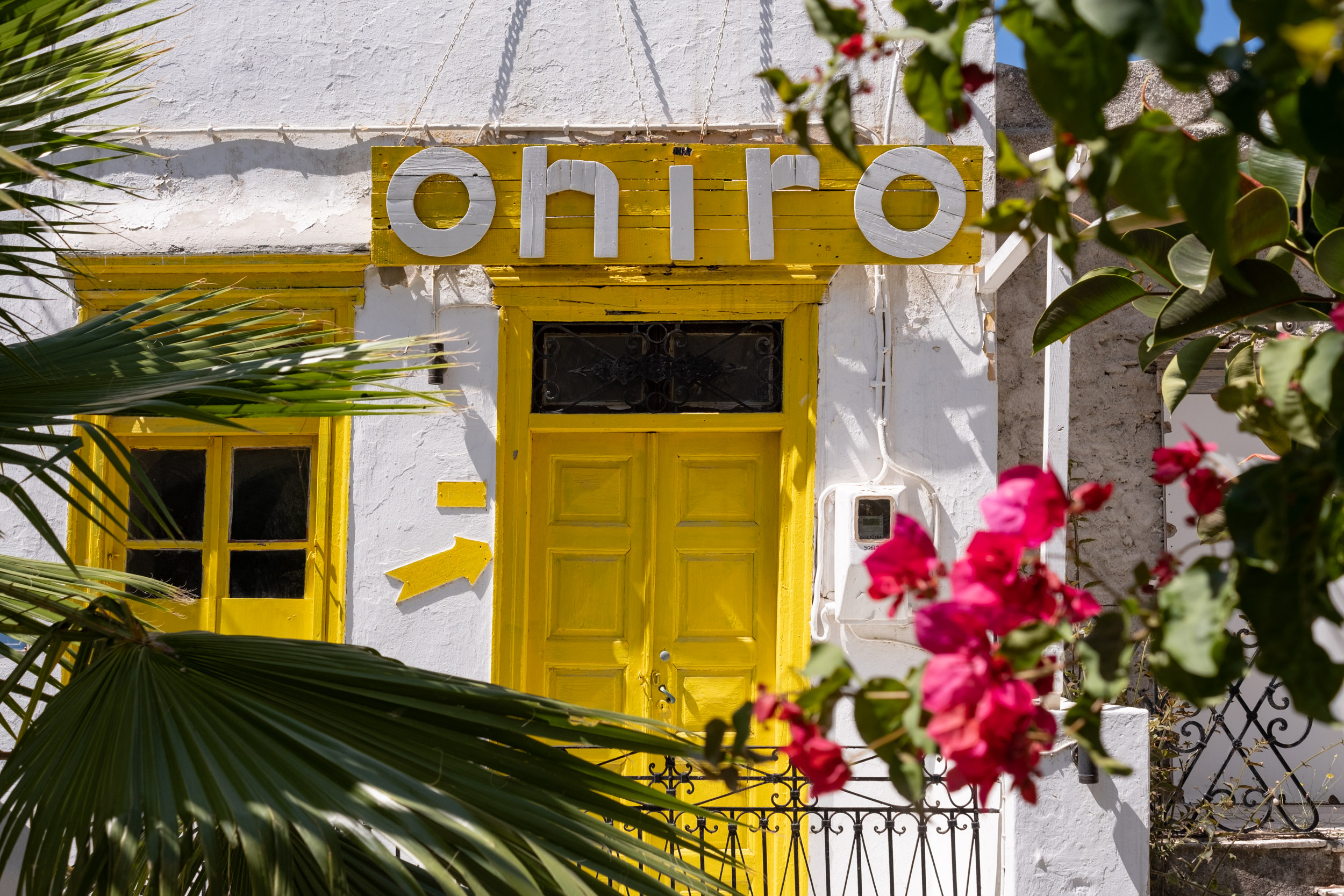 Beautiful yellow entry door to the "Oniro Wine Bar" on Naxos