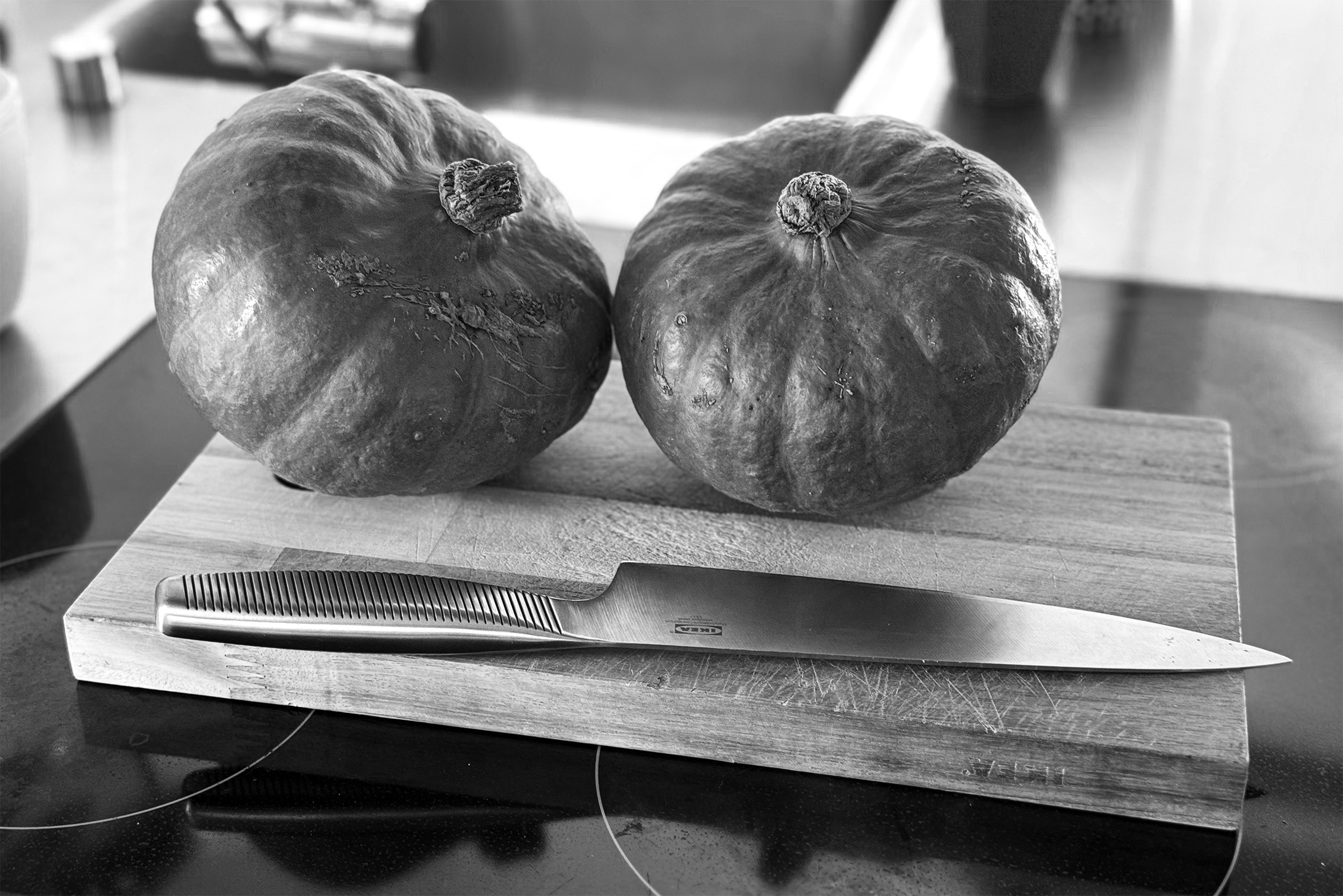 Pumpkins sitting on a cutting board, ready to be made into a delicious soup.