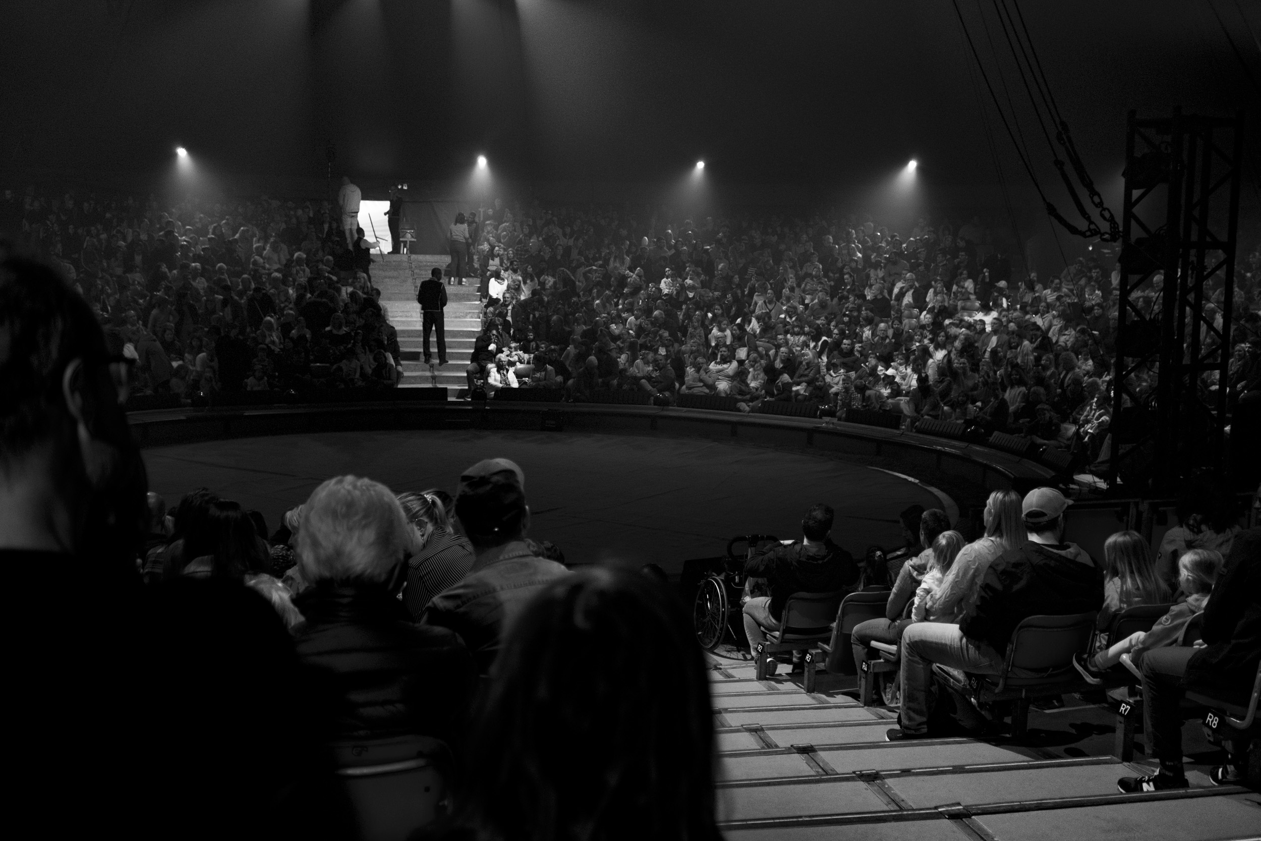 Circus ring at "Circus Knie", with people seating all around it, waiting for the show to start.