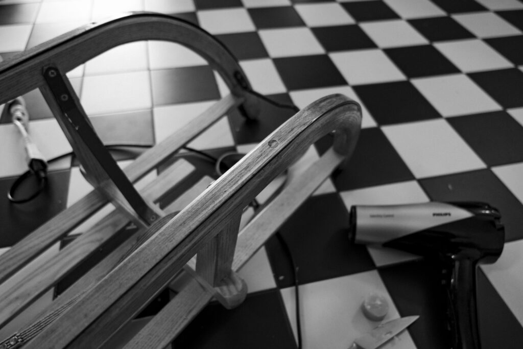 Sledge upside down on the floor, while I was trying to remove rust and wax it with what we had at home.