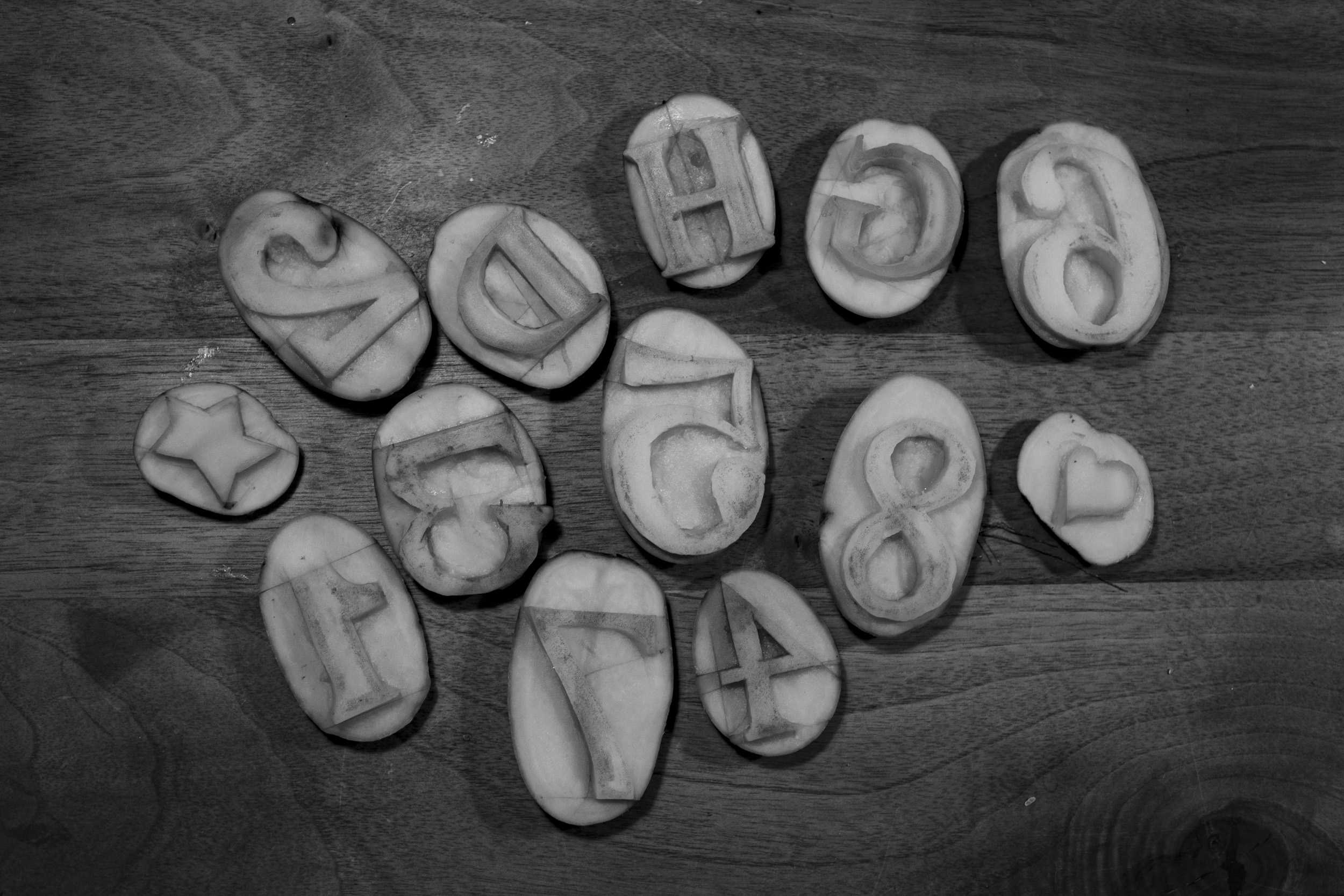 Potato stamps with some numbers and letters carved into them for T-shirt printing.